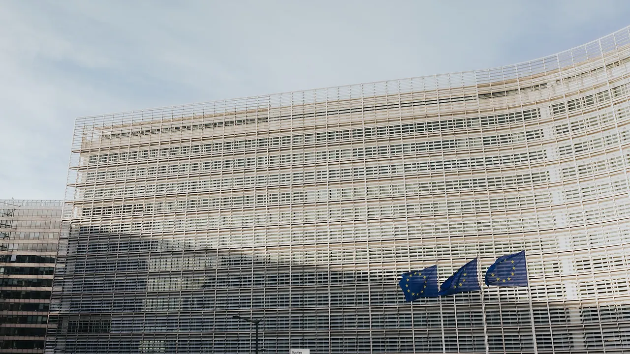 The Berlaymont building in Brussels with the European Union flag in front